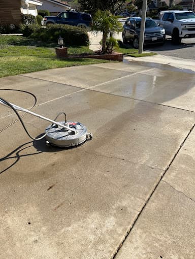 Driveway half cleaned with pressure washer